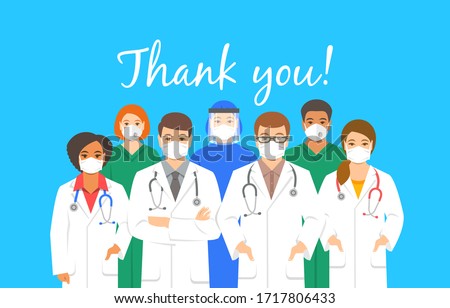 Doctors team in protective face masks with thank you inscription. Appreciation for hospital staff fighting the spread of coronavirus. Personnel of medical clinic, physicians and nurses stand together