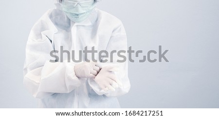 Image, Stock Photo Female doctor in coveralls holding COVID-19 PCR nasal swabbing kit