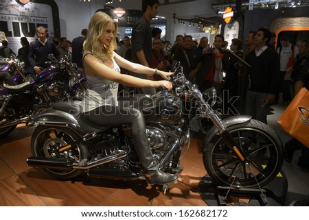 MILAN, ITALY - NOVEMBER 8: People visit Harley Davidson motorcycles and scooters exhibition area at EICMA, 71st International Motorcycle Exhibition on November 8, 2013 in Milan, Italy.