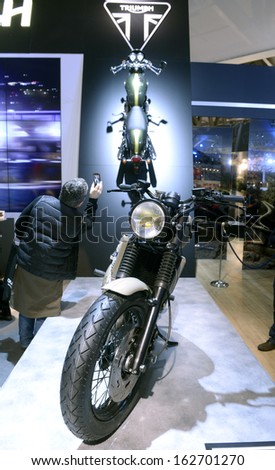 MILAN, ITALY - NOVEMBER 8: People visit Triumph motorcycles and scooters exhibition area at EICMA, 71st International Motorcycle Exhibition on November 8, 2013 in Milan, Italy.