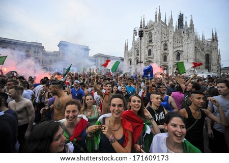 MILAN, ITALY - JUNE 28: Italian soccer fans watching the semi final between Italy vs Germany of the Euro 2012, celebrate in Duomo square of Milan June 28,2012.