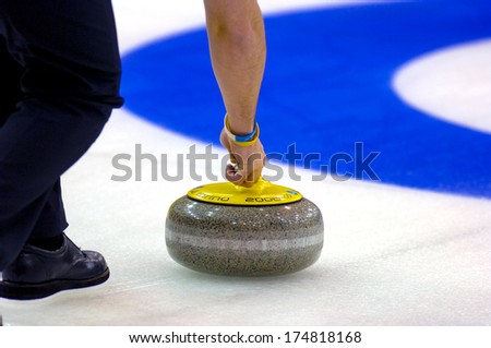 TURIN, ITALY-FEBRUARY 19, 2006: Close up of Curling stone launched to the target, during the Winter Olympic Games of Turin 2006.
