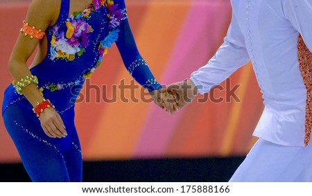 TURIN, ITALY-FEBRUARY 21, 2006: Couple hands holding while competing on the Figure Ice Skating competition, at the Winter Olympic Games of Turin 2006.