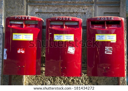 MILAN, ITALY-FEBRUARY 22, 2012: Red mail boxes outside a post office in Milan.
