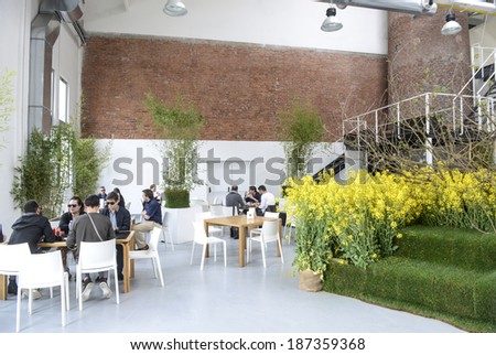 MILAN, ITALY-APRIL 08, 2014: Visitors having lunch at Fuorisalone in via Tortona, during the International Design Fair, Salone del Mobile, in Milan.