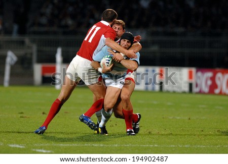 LYON, FRANCE-SEPTEMBER 12, 2007: argentinian rugby player, Juan Manuel Leguizamon, stopped by defense players during the rugby match Argentina vs Georgia, of the Rugby World Cup, France 2007, in Lyon.