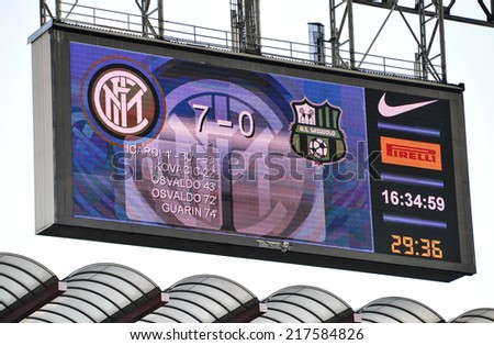 MILAN, ITALY-SEPTEMBER 14, 2014: electronic score board with soccer fans at San Siro stadium watching the Serie A professional soccer match Inter vs Sassuolo, in Milan.