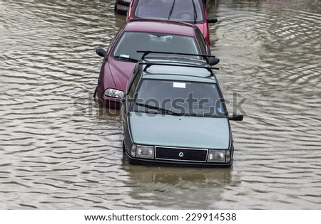 MILAN, ITALY-NOVEMBER 26, 2002: cars underwater on a flooded road during a flood caused by heavy rain, in Milan.
