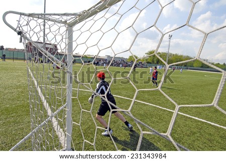 BIASSONO, ITALY-NOVEMBER 07, 2011: youth soccer tournament, seen from behind the goal post net, in Biassono.