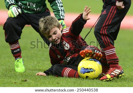 MILAN, ITALY-FEBRUARY 01, 2015: AC Milan young soccer players playing for soccer fans at the san siro stadium during the half time of a serie A match AC Milan vs Parma, in Milan.