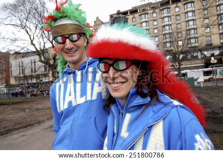 EDINBURGH, SCOTLAND-MARCH 18, 2007:  italian couple rugby fans wearing italian colors during the Six Nations rugby match Scotland vs Italy, in Edinburgh.