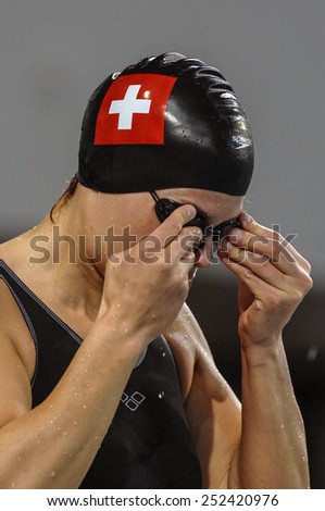EINDHOVEN, HOLLAND-MARCH 19, 2008: swiss female swimmer wearing swim cup and swim goggles at the European Swimming Championship, in Eindhoven.