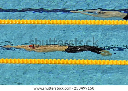 EINDHOVEN, HOLLAND-MARCH 22, 2008: male swimmers emerging from water during a back stroke race of the European Swimming Championship, in Eindhoven.