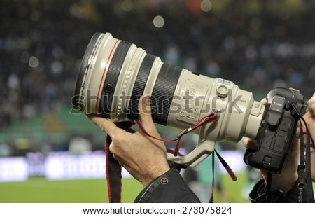 MILAN, ITALY-APRIL 19, 2015: sports photographer shooting picture with Canon lens, at the san siro soccer stadium, in Milan.