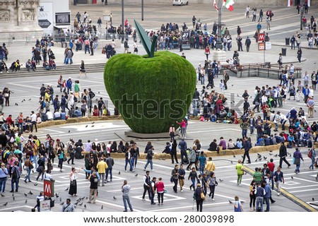 MILAN, ITALY-MAY 05, 2015: top view of people walking in Duomo square, with the apple  art installation of the Italian artist Pistoletto, in Milan.