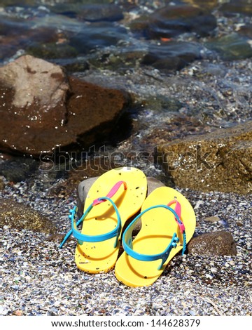 flip flops in the water line at a beach