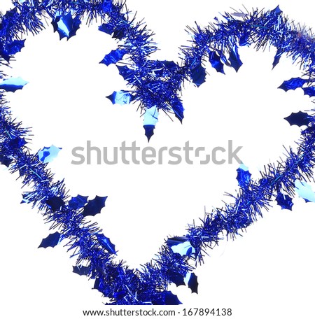 Christmas blue tinsel in form of heart. Whole background.