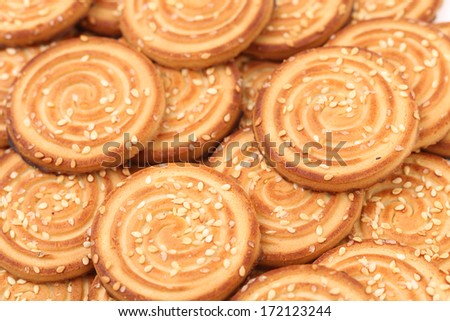 Round cookies with sesame seeds. Whole background.