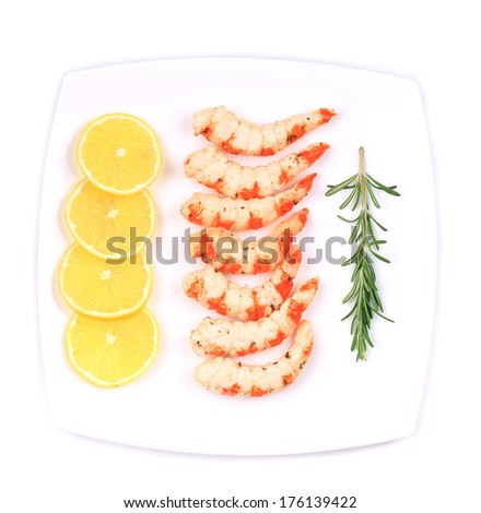 Cooked unshelled shrimps with lemon. Isolated on a white background.