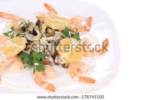 Shrimp salad with mushrooms and white sauce. Isolated on a white background.