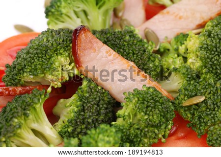 Broccoli salad with pumpkin seeds and tomatoes. Whole background.