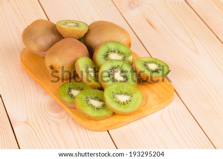 Kiwi fruits cut and whole. Whole background.