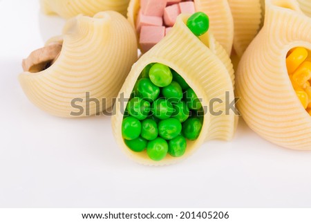 Pasta shells stuffed with vegetables and sausage. Whole background.