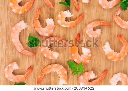 Boiled shrimps on cutting board. Isolated on a white background.