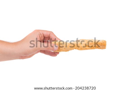 Hand holding stick cracker with sesame seeds. Isolated on a white background.