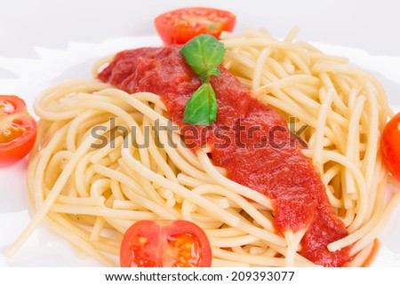 Pasta with tomato sauce and basil. Isolated on a white background.
