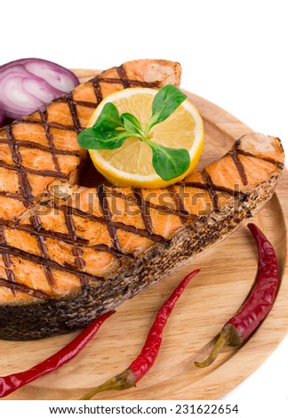 salmon fillet with lemon. Isolated on a white background.