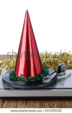 Shiny party hat on record player on a white background