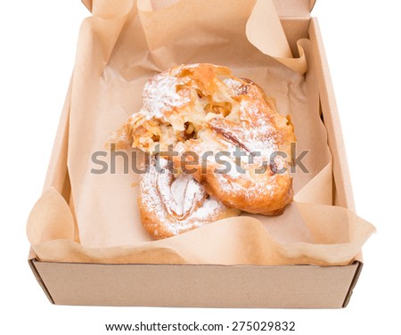 Heat apple puff cake in cardboard box. Isolated on a white background.