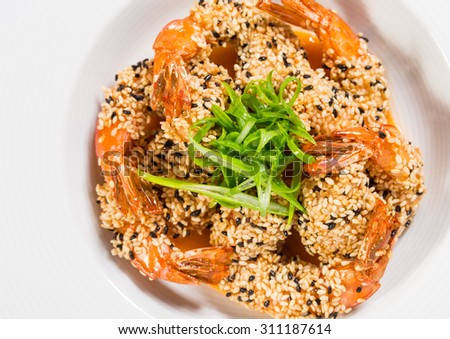 Delicious grilled jumbo shrimps with sesame and sliced scallions. Macro. Photo can be used as a whole background.