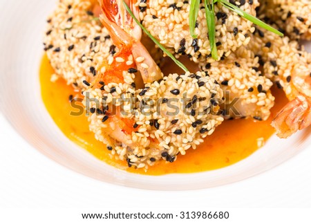 Delicious grilled jumbo shrimps with sesame and sliced scallions on yellow mousse. Macro. Photo can be used as a whole background.