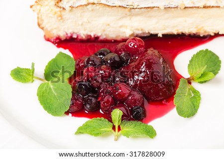 Traditional cheesecake with berry jam and fresh mint. Macro. Photo can be used as a whole background.