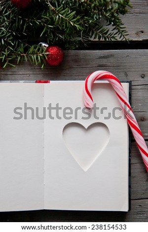 note book and christmas items on wooden table
