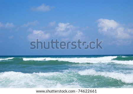 Running waves under the blue sky. Mediterranean sea.
