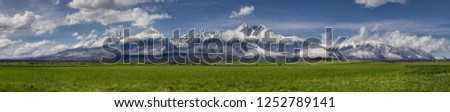 Extra wide panorama of High Tatra mountains during April with snowy hills,  blue sky with fluffy clouds, Vysoke Tatry, Slovakia Foto stock © 