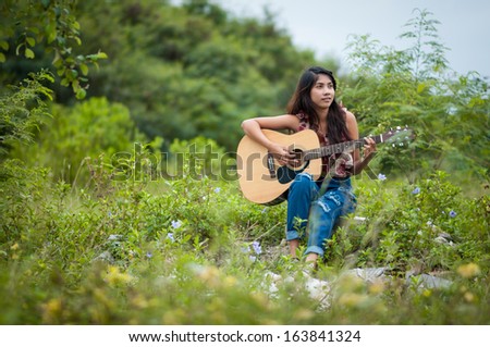 Musician woman and her guitar in good day