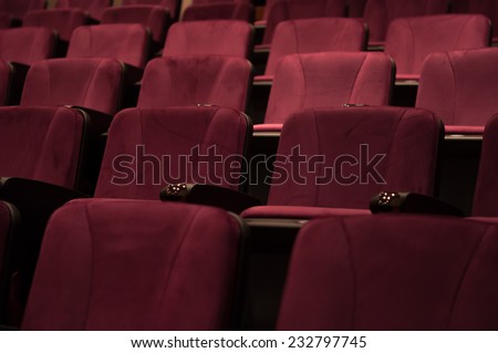 Row of empty red seats for cinema, theater, conference or concert