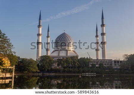 a beautiful view of Sultan Salahuddin Abd Aziz Mosque or Masjid Negeri Shah Alam (in Malay) with reflection from the lake, sunrise moment