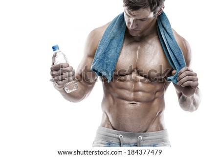 Strong Athletic Man Fitness Model Torso showing six pack abs. holding bottle of water and towel