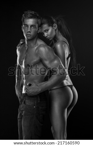 half-naked sexy couple, beautiful woman holding a muscular man isolated on a white background