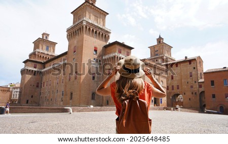 Travel in Italy. Back view of beautiful tourist girl enjoying view of Este Castle (Castello Estense) of Ferrara, Italy. Imagine de stoc © 