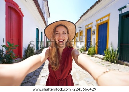 Similar – Image, Stock Photo Happy tourist woman taking pictures of the old town with a retro camera