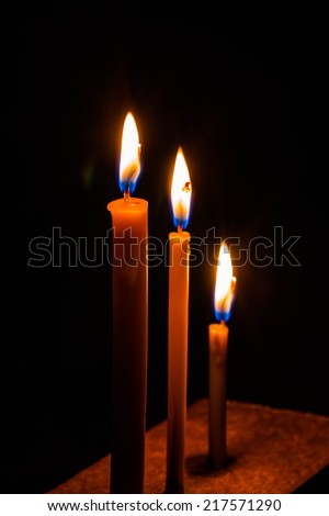 Candle and light in dark black
