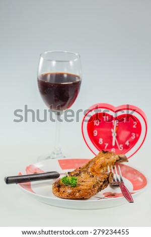juicy grilled pork chop with Heart Clock,Drink Wine for dinner time