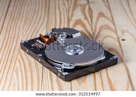 Hard disk drive inside. Data safety concept. wooden background