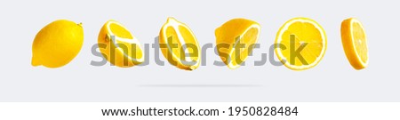 Juicy ripe flying yellow lemons on light gray background. Creative food concept. Tropical organic fruit, citrus, vitamin C. Lemon slices. Summer minimalistic bright fruit background. Pattern